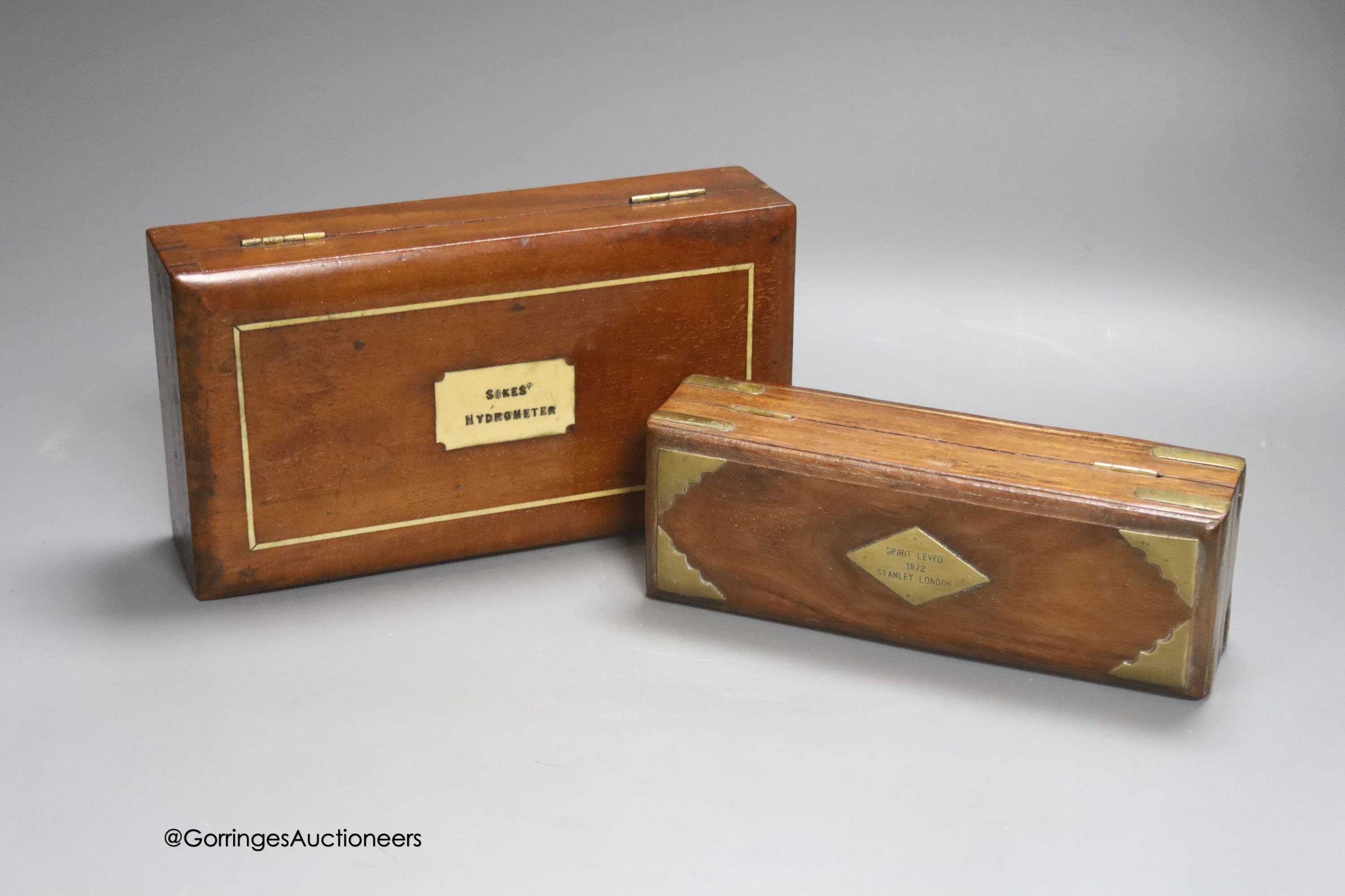 A Stanley, London spirit level, 1872 (cased) and a Sykes Hydrometer (cased)